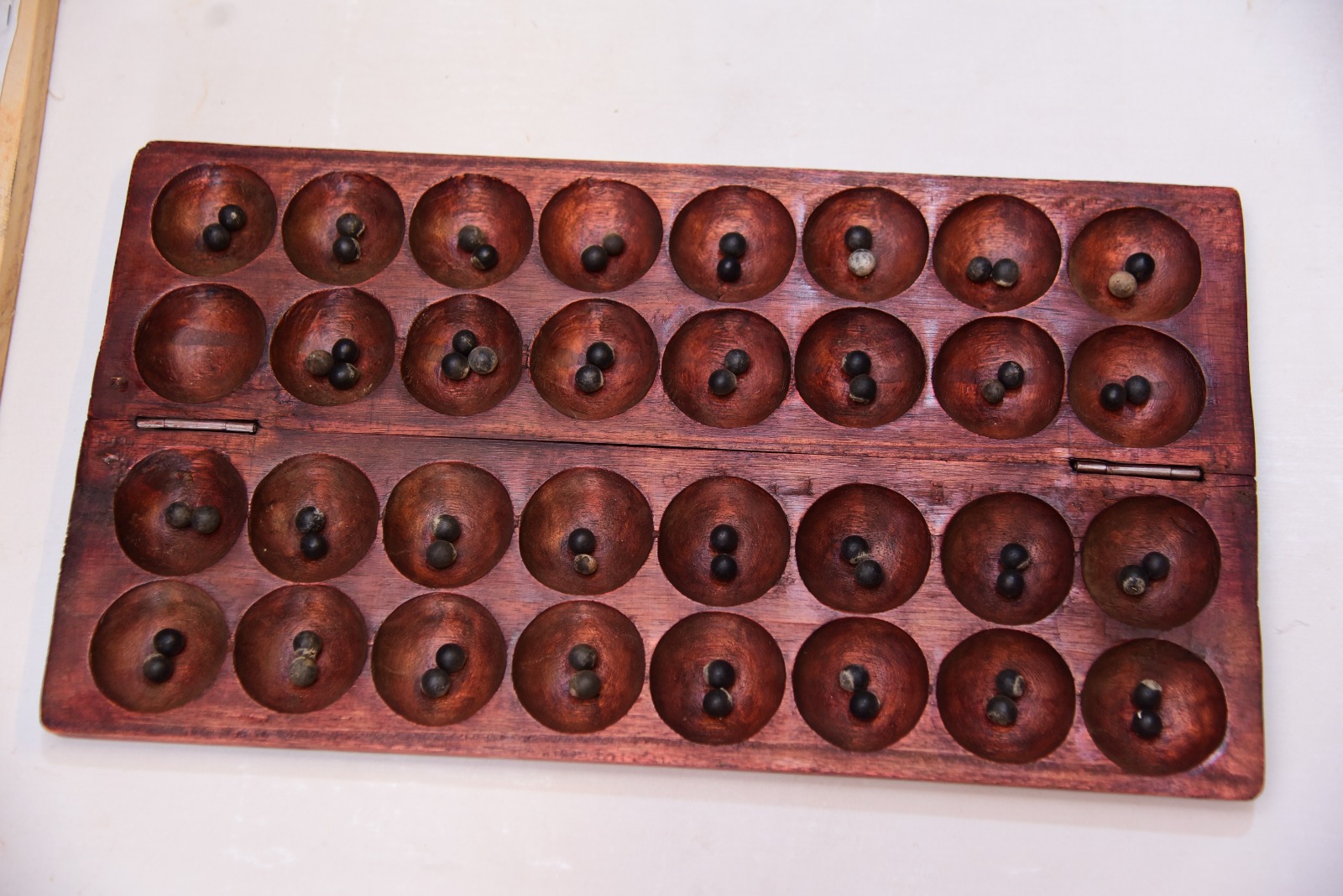 The Buganda Kingdom Hand-Carved Wooden Omweso Board Game